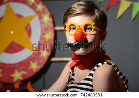 the boy in the costume of a strongman in the circus