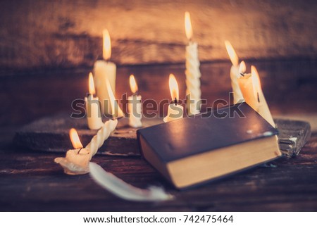 black magic, background: candles and black book