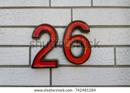 number 26 house number on the wall twenty six (26)