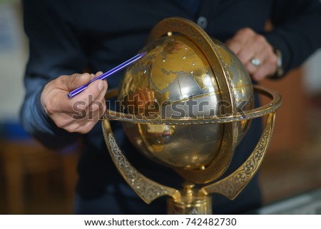 Hands showing a globe