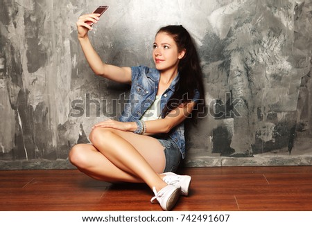 Pretty hipster girl taking selfie.
