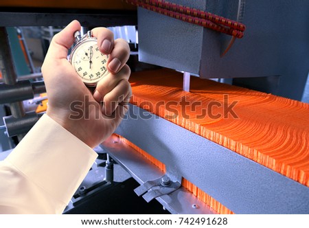 Process of paper products manufacturing and stopwatch in male hand