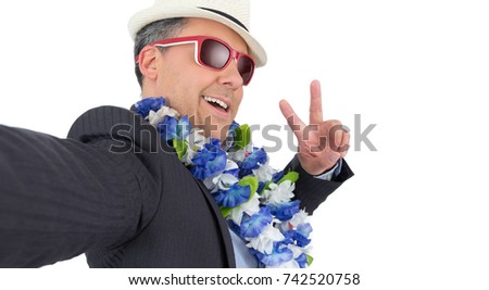 Party man takes picture with his cellphone. POV. Perspective. Selfie. He is wearing a Hawaiian flower necklace and sunglasses. Carnival holiday concept, joy, party and fun.