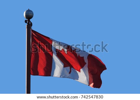 Waving Canadian flag against blue sky for celebrating Canada 150 years