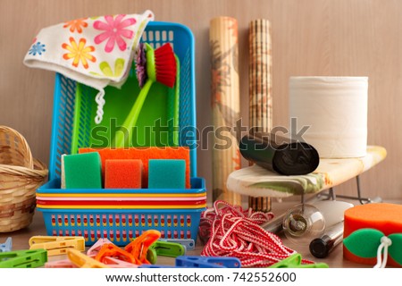 Many household goods. Ironing board, plastic boxes, toilet paper, garbage bags, parallon sponges, clothespins are household utensils. Household items for everyday life. Royalty-Free Stock Photo #742552600