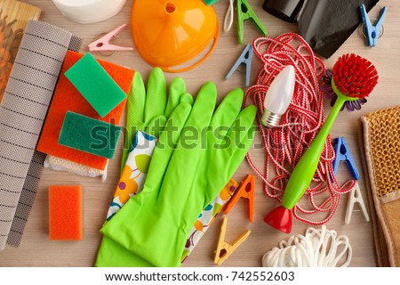Household goods. View from above. Rubber gloves, clothesline, sponges, clothespins, electric lamp are household utensils. Household items for everyday life. Royalty-Free Stock Photo #742552603
