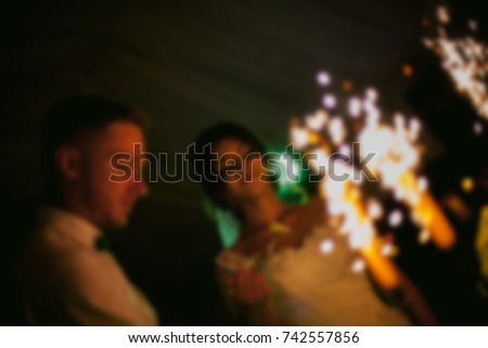 newlyweds cut a birthday cake. blurred image of bride and groom cutting wedding cake. beautiful newlyweds cutting stylish cake, celebrating wedding. wedding day. blurred image / soft focus
