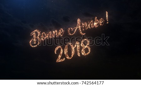 2018 Happy New Year greeting text in French with particles and sparks on black night sky with colored fireworks on background, beautiful typography magic design.