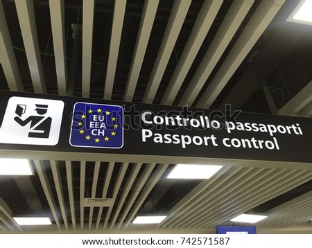 Passport control sign. Airport signs. European Union passport control. Departure and arrivals. Travel Italy. Italian border. Royalty-Free Stock Photo #742571587