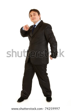 Full length portrait of pleased young businessman cheerfully dancing isolated on white