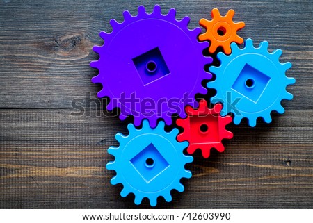 Moving forward concept with gears. Right decision and correct solution. wooden desk background top view mockup
