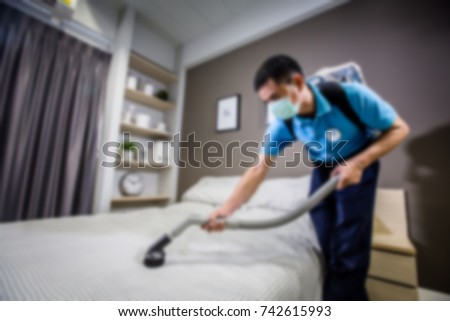  Picture blurred for background abstract and can be illustration to article of sanitary. Man wearing mask clean bed with vacuum Royalty-Free Stock Photo #742615993