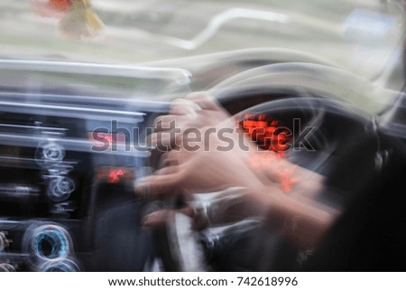Picture blurred of hand holding the steering wheel