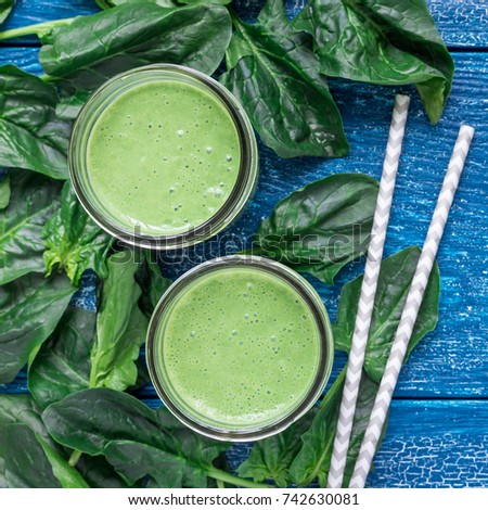 Detox green smoothie with spinach, pineapple, banana and yogurt, top view, square format