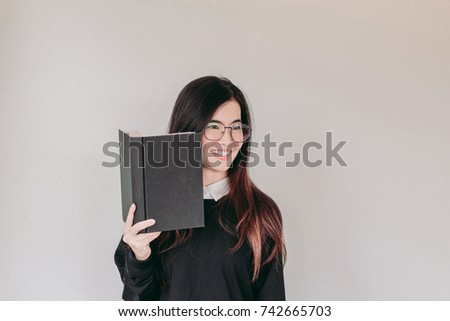 Young asian Student woman holding book with copy space

