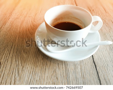 white cup of coffee on wooden table background