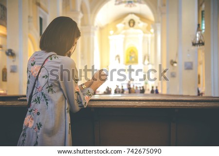 Christian woman is holding hands together and praying in the church, Worship god with christian concept religion.