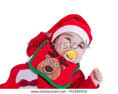 Baby girl with pacifier or dummy, red bodysuit, reindeer bib and Santa Claus hat for Christmas. Isolated white background. Four months old