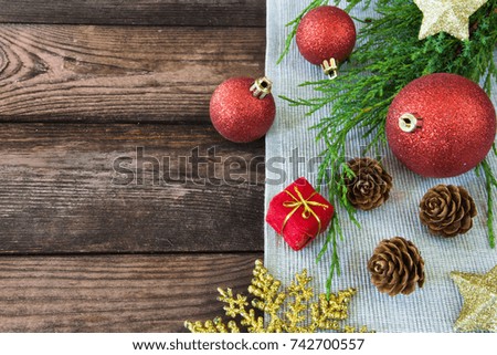 Christmas decoration decorations, bows, ribbons, fir branches, Christmas balls on a wooden background with copy space festive mood and atmosphere