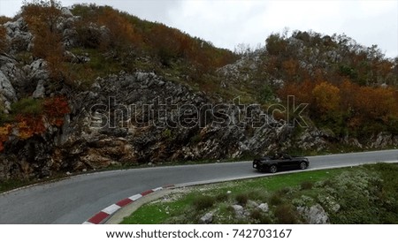 Beautiful Summer Mountain Road. Footage. A car travels along on a twisty mountain road. New winding road in the mountain