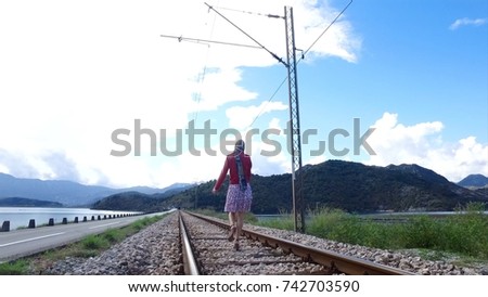 Walking girl on the railway under the blue sky. Footage. Walking girl on the railway under the blue sky. Happy asian woman travel taking photo at railway station, Concept of holiday and travel