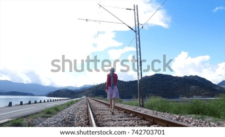 Walking girl on the railway under the blue sky. Footage. Walking girl on the railway under the blue sky. Happy asian woman travel taking photo at railway station, Concept of holiday and travel