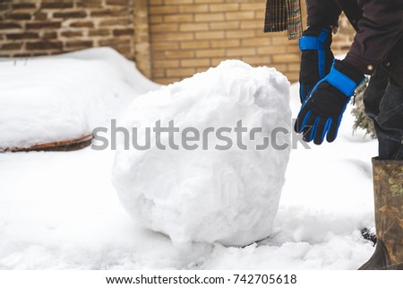 Hands in the ski gloves creates a snowball winter day
