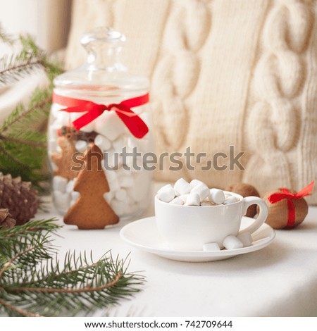 Christmas gingerbread, candy, coffee with marshmallows in white cup, knitted pillow, Xmas holidays background, winter home cozy