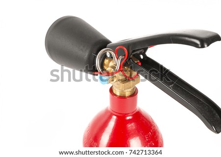 Detailed view of an red extinguisher on a white background