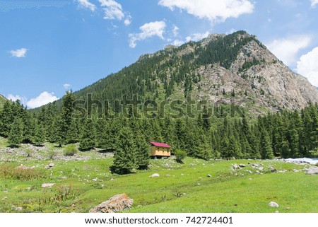 Cabin near mountains and forest