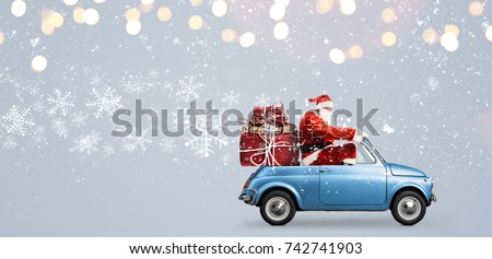 Santa Claus on car delivering Christmas or New Year gifts at snowy gray background Royalty-Free Stock Photo #742741903