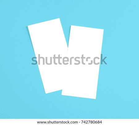 Blank flyer over blue background to replace your design