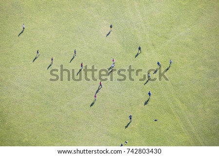 people on the green field from above 