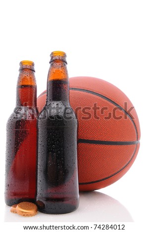Two open beer bottles and a basketball on a white background with reflection. Vertical format from a low angle. 