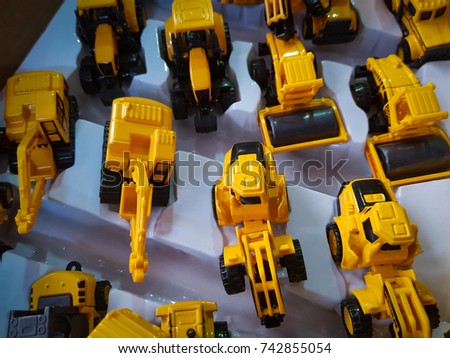 Yellow toys truck and dump truck