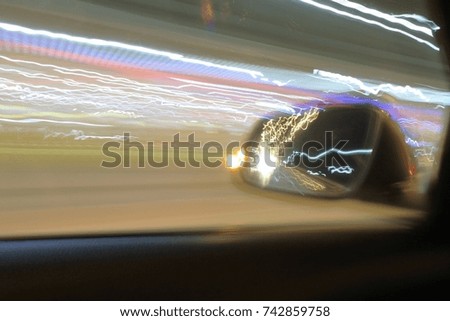 Blur picture of light lines of neon on the road when he is driving fast at night 