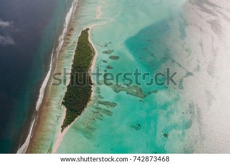 The tropical islands and atolls in Maldives in Indian Ocean from aerial view. Piece of paradise on the Earth. Good choice for vacation. Beautiful top view for wallpaper.