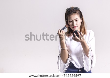 Beautiful Asian woman with Makeup Brush