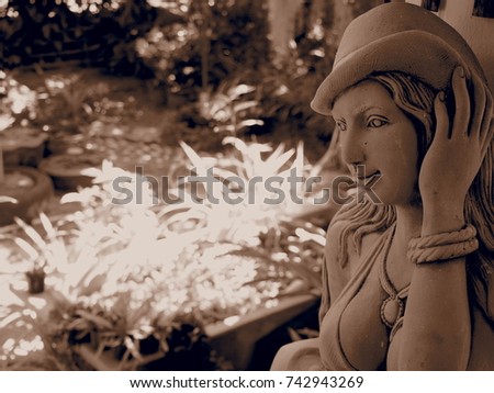 closeup statue woman with park background in monotone