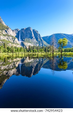 Yosemite National Park - Reflection in Merced River of Yosemite waterfalls and beautiful mountain landscape, California, USA