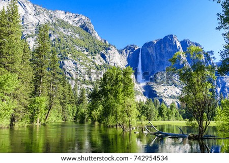 Yosemite National Park - Reflection in Merced River of Yosemite waterfalls and beautiful mountain landscape, California, USA