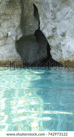 Sea level photo of turquoise clear water seascape full of caves