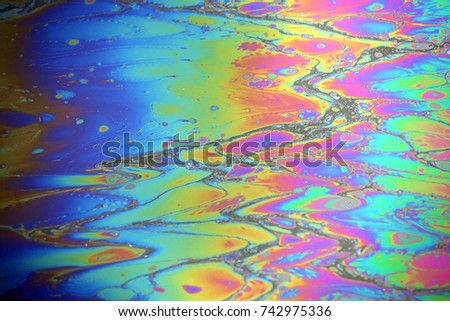Abstract colorful rainbow oil slick on water background Royalty-Free Stock Photo #742975336