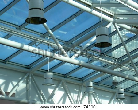Glass and steel interior of building with sunlight and shadows