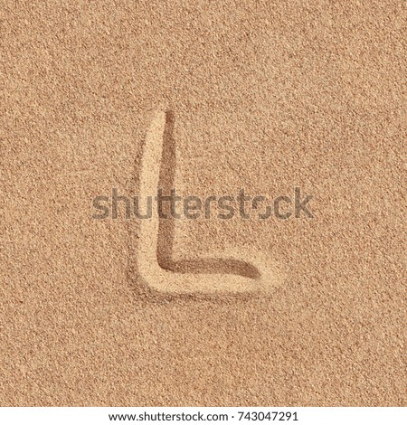 Handwritten letter l alphabet on a beach sand Royalty-Free Stock Photo #743047291