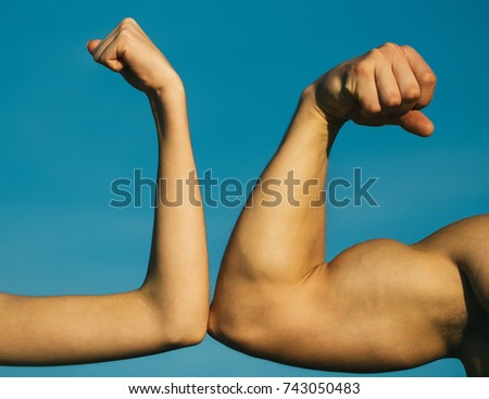 Competition, strength comparison. Vs. Fight hard. Health concept. Hand, man arm, fist. Musclar arm vs weak hand. Royalty-Free Stock Photo #743050483