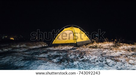 Camping for a starry night. The tent glows under the night sky full of stars. Milky Way. leisure tourists.  for friends
