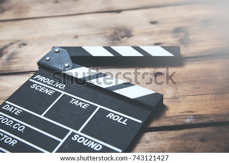 vintage photo shot of movie clapper on wooden table