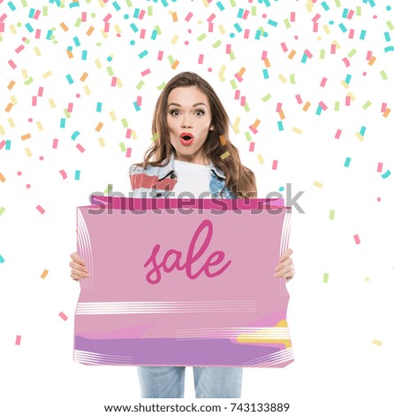 Attractive shocked woman holding pink sale banner with flying confetti