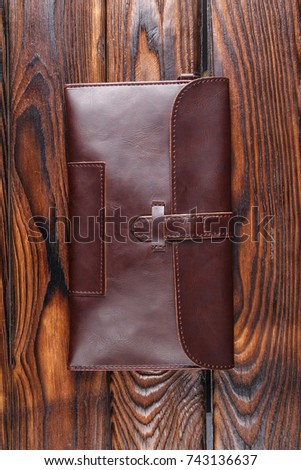 Leather wallet close-up on a brown wooden table